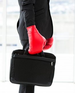 businessman wearing suit and boxing gloves
